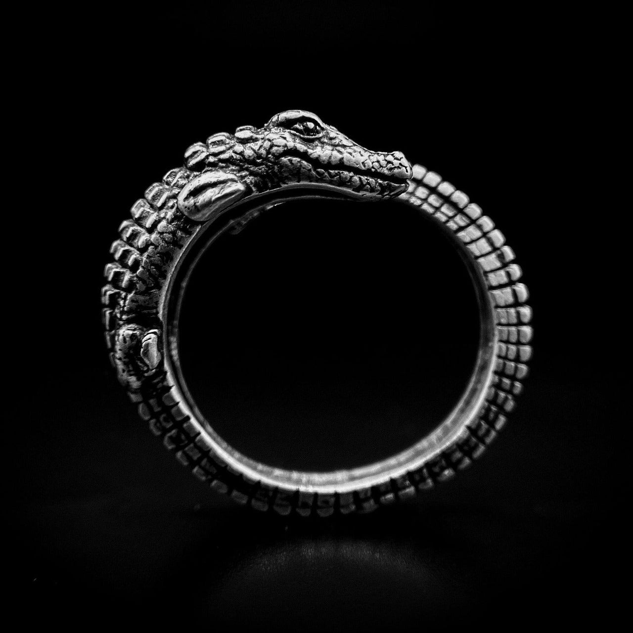Crocodile ring on a black background by Black Feather Design