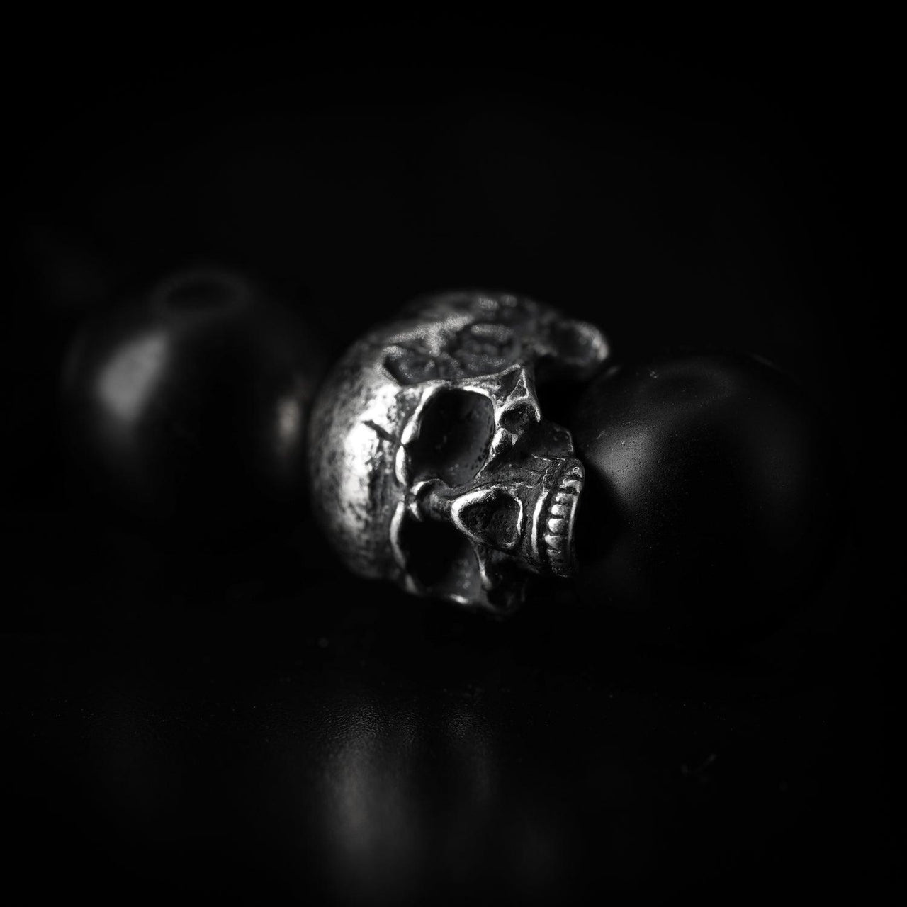 Close up of Sterling Silver Skull Bracelet - Black Feather Design