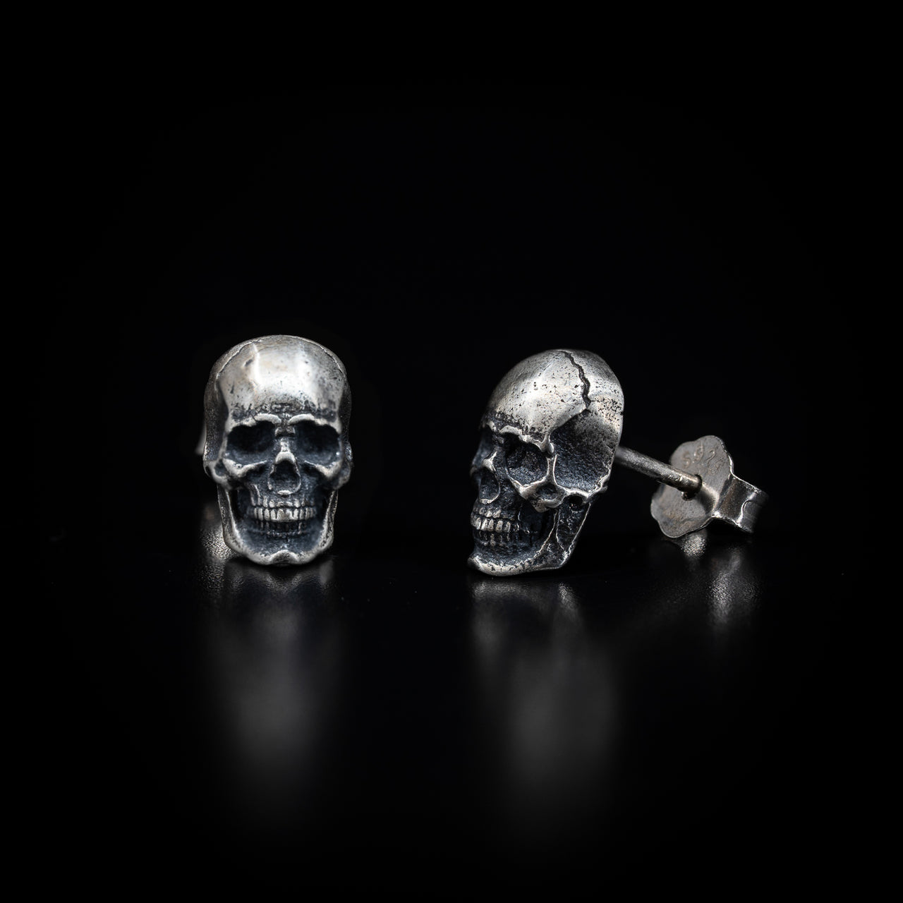 skull stud earrings in sterling silver by Black Feather Design